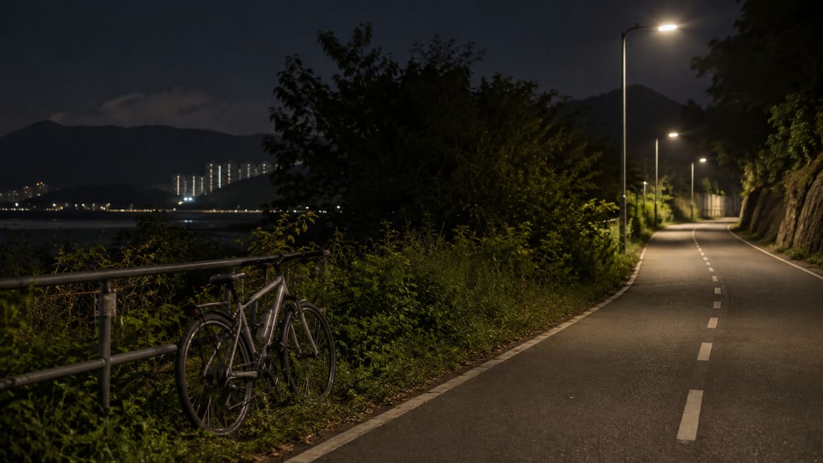 AI illustration: Parked bicycle beside a quiet cycle path at night.